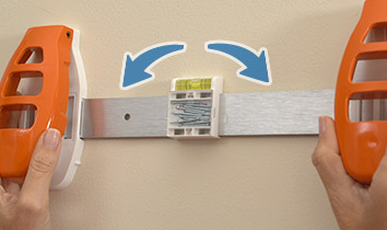 Positioning Hang Hero™ to the wall and leveling